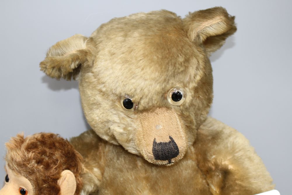 A Chiltern Hugmee bear c.1930s, 22in., velvet paids in dirty condition but good mohair, glass eyes and a Schuco Yes/No monkey, 14in.,